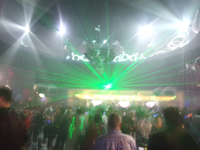 A busy dance floor under bright stage lights