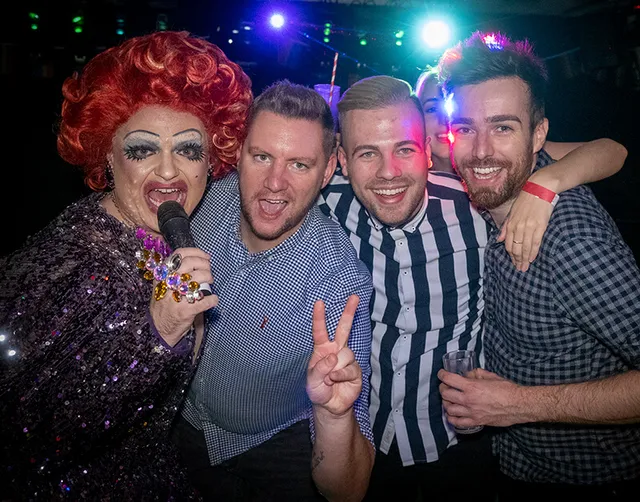 A group of costumed guests posing at a party