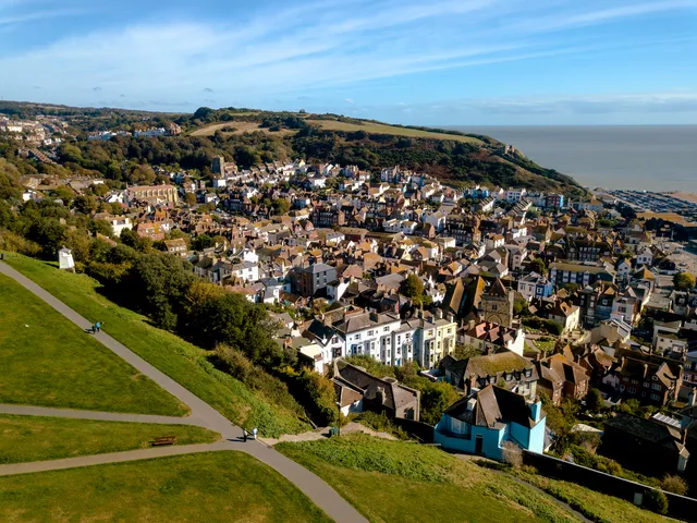 Aerial view across a coastal town toward the sea